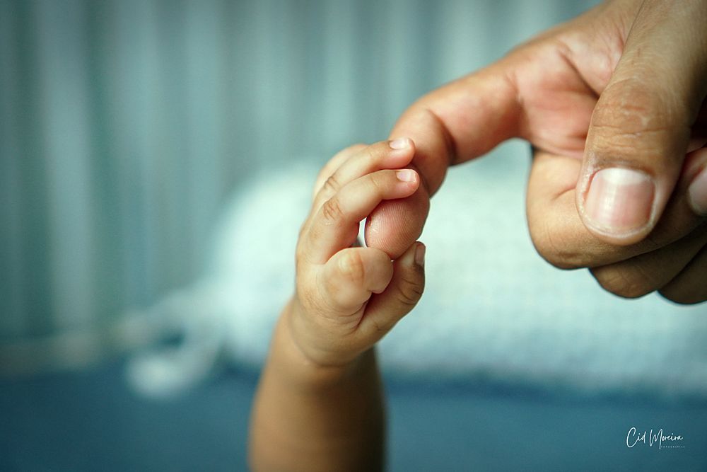Mão de bebê recém-nascido segurando o dedo de adulto - Fotografia de Parto e Nascimento em Fortaleza por Cid Moreira